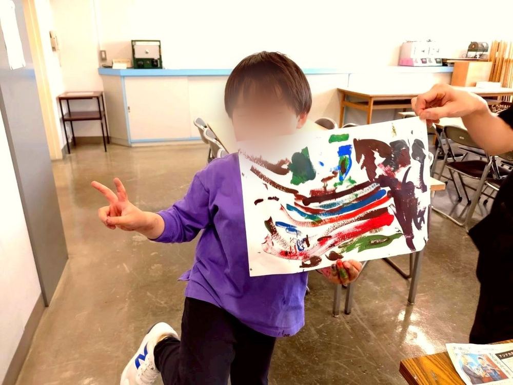 A boy showing his drawing
