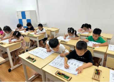 Children practicing with worksheets and soroban