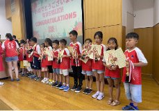 Children holding certificates and medals