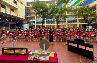 Students gathered in the schoolyard with a giant soroban