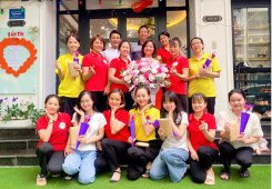 A group photo around a bouquet of flowers